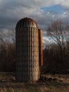 Vertical shot of big old silos in agricultural field Royalty Free Stock Photo
