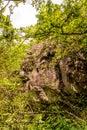 Vertical shot of a big rock on the path to the giant bench in Rogno Royalty Free Stock Photo