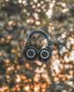 Vertical shot of a black Audio Technica headphone ATH M50x in the air