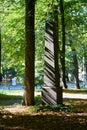 Vertical shot of a black granite gravestone tower at the Great Cemetery in Riga, Latvia