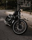 Vertical shot of the black Harley-Davidson parked on the street.