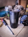 Vertical shot of a black patriotic coffee mug with vertical united states flag