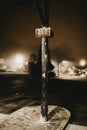 Vertical shot of a black pole with a sign that says