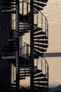 Vertical shot of black winding stairs outside of the building