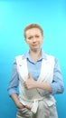 Vertical shot. blonde woman without makeup on a blue background. sign super