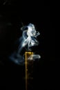 Vertical shot of a blown-out candle with smoke isolated on a black background Royalty Free Stock Photo