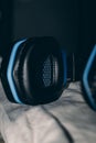 Vertical shot of a blue and black headset placed on a white cloth