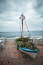 Vertical shot of a blue boat decoration on a beach cafe