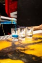 Vertical shot of a blue drink being poured into a glass on the bar stand Royalty Free Stock Photo