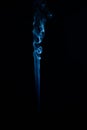 Vertical shot of blue tobacco smoke on a black background Royalty Free Stock Photo