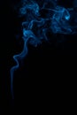 Vertical shot of blue tobacco smoke on a black background Royalty Free Stock Photo