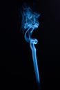 Vertical shot of blue tobacco smoke on a black background Royalty Free Stock Photo