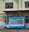 Vertical shot of a blue van used as a canteen on a street of Athens