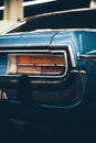 Vertical shot of a blue vintage car`s backlight with a blurred background Royalty Free Stock Photo