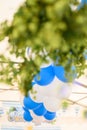 Vertical shot of blue and white balloons with green foliage. Oktoberfest, Germany.