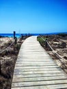 Vertical shot of the boardwalk next to a beach in Formentera, Spain Royalty Free Stock Photo