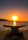 Vertical shot of a boat dock anchor with a beautiful sea view at sunset Royalty Free Stock Photo