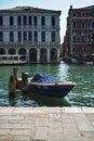 Vertical shot of a boat moored onto a dock in Venice, Italy