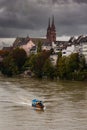 Vertical shot of a Boat riding along the river Rhine with the cathedral, Basel Switzerland