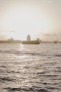 Vertical shot of a boat sailing on the Nieuwe Maas river in Rotterdam Royalty Free Stock Photo