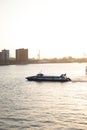 Vertical shot of a boat sailing on the Nieuwe Maas river in Rotterdam Royalty Free Stock Photo