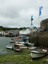 Vertical shot of the boat on the water captured in Harbour Mevagissey, UK Royalty Free Stock Photo