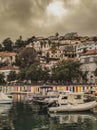 Vertical shot boats at the dock in Herceg Novi with houses and the gloomy sky in the background Royalty Free Stock Photo