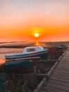Vertical shot of boats parked on the shore during the sunset in Whitstable, UK