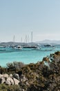 Vertical shot of boats sailing on the sea with a  blue sky in the background Royalty Free Stock Photo