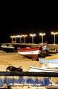 Vertical shot of boats on the sandy beach at night, street lamps lighting in Sal Island,Cape Verde