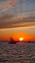 Vertical shot of boats in the sea with a beautiful orange sunset in the background, Costa Rica Royalty Free Stock Photo