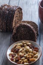 Vertical shot of a bowl of cashews next to rye bread