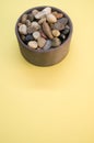 Vertical shot of a bowl filled with rocks and pebbles Royalty Free Stock Photo