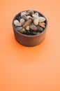 Vertical shot of a bowl filled with rocks and pebbles Royalty Free Stock Photo