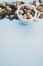 Vertical shot of a bowl and small rocks on a blue surface Royalty Free Stock Photo