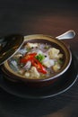 Vertical shot of a bowl of vegetable soup on a wooden table Royalty Free Stock Photo