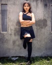 Vertical shot of a brave philippine teenage girl standing outdoors with stylish clothes