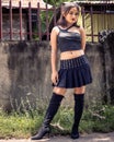 Vertical shot of a brave philippine teenage girl standing outdoors with stylish clothes