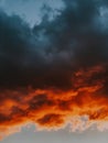 Vertical shot of breathtaking orange and black clouds during sunset - great for background Royalty Free Stock Photo