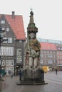 Vertical shot of the Bremen Roland statue with old buildings in the background on a gloomy day