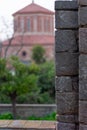 Vertical shot of brick wall with a blurred big red house on the background Royalty Free Stock Photo