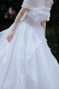 Vertical shot of the bride leaning right in a beautiful white wedding dress Royalty Free Stock Photo