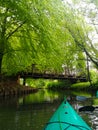 Vertical shot of a bridge over a river and a boat floating on the water Royalty Free Stock Photo