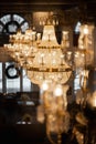 Vertical shot of bright chandeliers inside a building in Boston