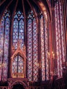 Vertical shot of bright colorful stained glass windows in a church