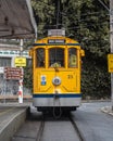 Vertical shot of a bright yellow streetcar at Santa Teresa, Rio de Janeiro