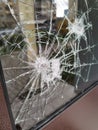 Vertical shot of a broken glass window Royalty Free Stock Photo