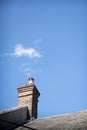 Vertical shot of a building chimney with clouds like smoke