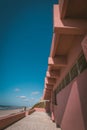 Vertical shot of a building near the beach under a blue sky Royalty Free Stock Photo