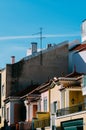 Vertical shot of buildings and rooftops under blue sky Royalty Free Stock Photo